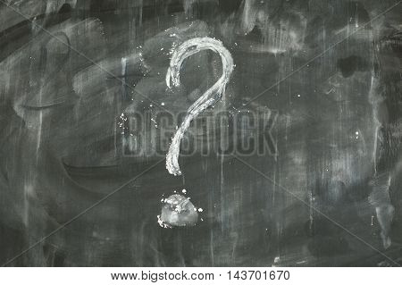 Question mark written on a dirty blackboard