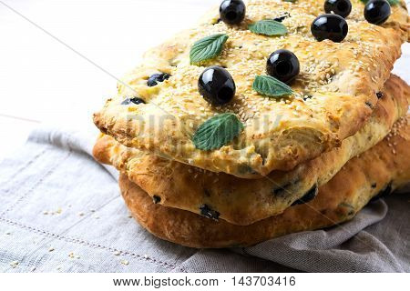 Stack of traditional Italian bread focaccia on the linen napkin. Homemade traditional Italian bread focaccia.