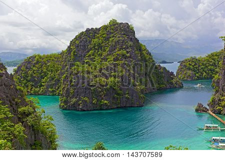 Panorama of Coron Island Philippines. Traditional Pilipino boats at the sea pier.