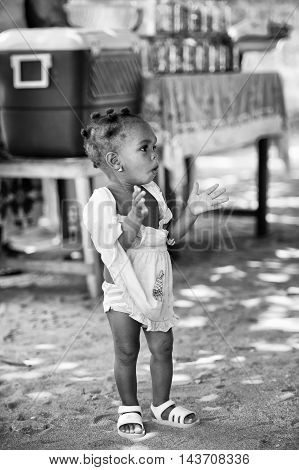 KARA, TOGO - MAR 9, 2013: Unidentified Togolese girl claps her hands in the street. Children in Togo suffer of poverty due to the unstable econimic situation