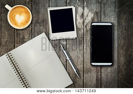 Mobile Phone, Notebook Pen, Photo Frame And Coffee Cup On Office Wooden Table With Copy Space.