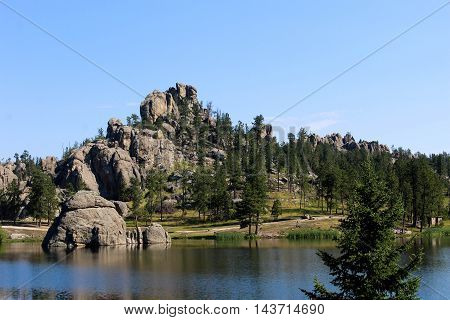 Rock formations near a quiet lake in the woods