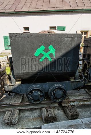 Old mining cart in Spania Dolina Slovak republic. Symbol of miners. Travel destination. Vertical composition.