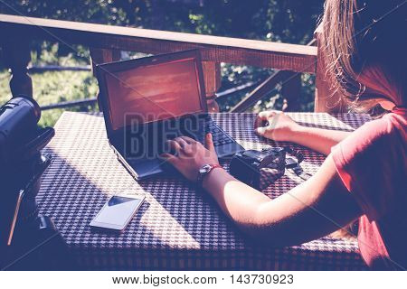 Girl working with notebook in the garden