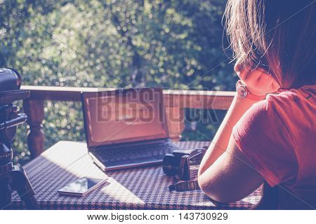 Girl working with notebook in the garden