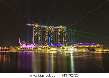 SINGAPORE SINGAPORE - SEPTEMBER 28 2013 : Laser and lighting performance of Marina Bay Sands luxury hotel shopping mall and resort the best night tourist attraction in Singapore.