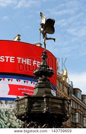 LONDON ENGLAND - JULY 8 2016: Piccadilly Circus neon signage and the Statue of Eros on top of the Shaftesbury Memorial a famous public space in West End.