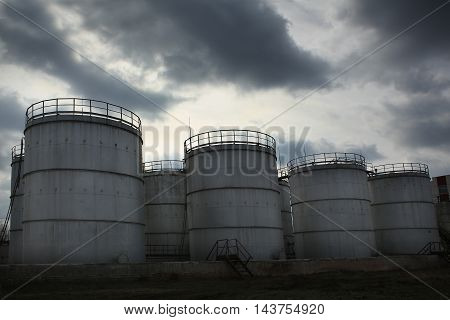 the a oil factory against storm clouds