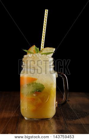 orange, lemon and lime mix. fresh cocktail. citrus juice. black background