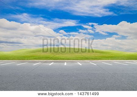 parking lot parking lane outdoor with green grass and beautiful blue sky background
