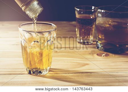 Pour alcohol placed on a wooden background.