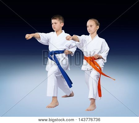 Two karate kids are beating punch arm