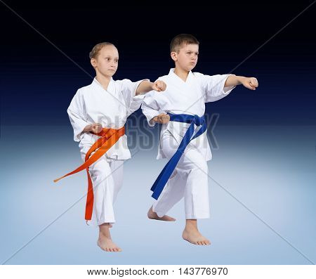 With blue and orange belt athletes are beating punch arm