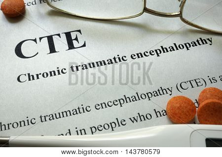 Paper with words CTE, Chronic Traumatic Encephalopathy  and glasses. Medical concept.