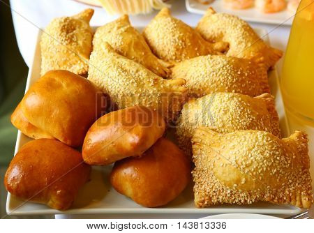 country pies with meat and seasame seeds close up photo