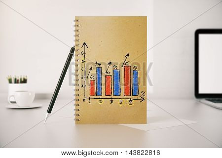 Workplace with business chart in spiral notepad. 3D Renering