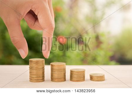 business hand holding money gold coin with business investment saving finance and banking concept.