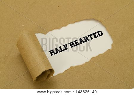 HALF HEARTED word written under torn paper.