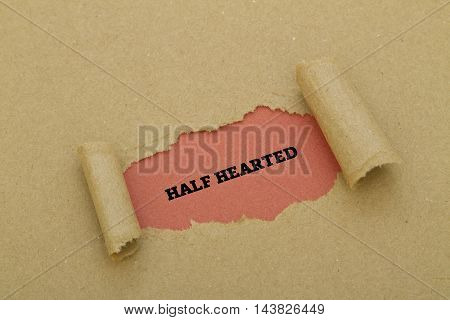 HALF HEARTED word written under torn paper.