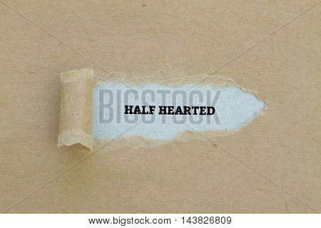 HALF HEARTED word written under torn paper.