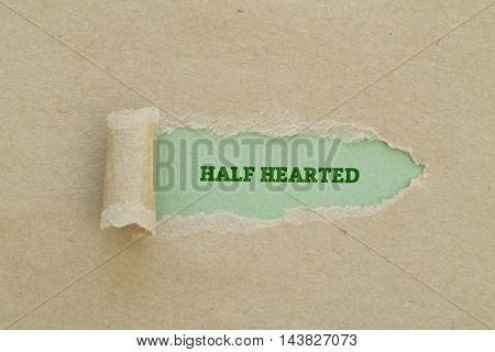 HALF HEARTED word written under torn paper.