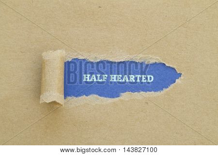 HALF HEARTED word written under torn paper.