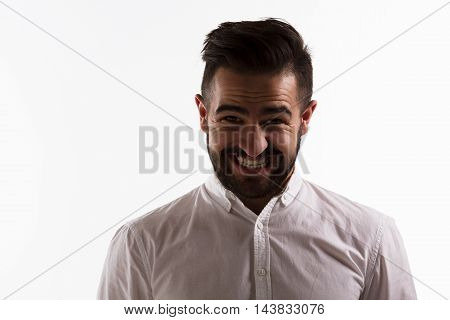 Picture of handsome hispter man toothy smiling isolated on white background. Young man in white shirt posing in studio. Hard light concept.