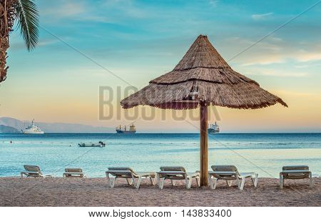 Relaxing atmosphere on the public beach of Eilat - famous resort city in Israel