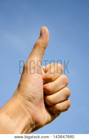asia men thumbs up blue sky background