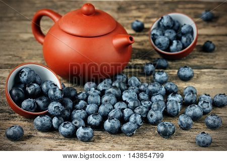 Freshly picked blueberries. Juicy and fresh blueberries. Bilberry on wooden background. Blueberry antioxidant. Concept for healthy eating and nutrition selective focus
