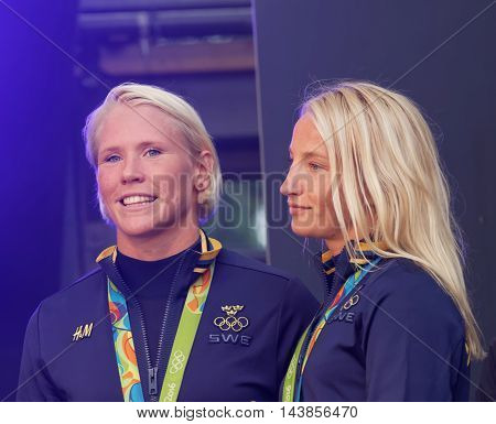 STOCKHOLM SWEDEN - AUG 21 2016: Happy swedish female wrestler Jenny Fransson and Sofia Mattson when swedish olympic athletes are celebrated in Kungstradgarden 