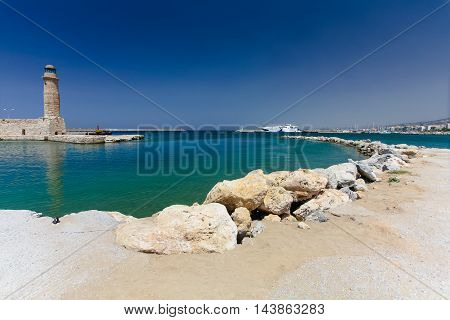 Rethymnon, Island Crete, Greece, - July 1, 2016: Old venetian lighthouse and harbor. Rethymnon is an old historic town on the northern coast of the island Crete.