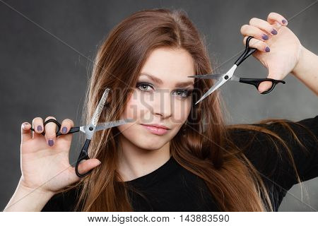 Elegance and classy. Fashion style of hairdo. Female professionalist with scissors. Elegant woman presents her hairdresser's saloon.