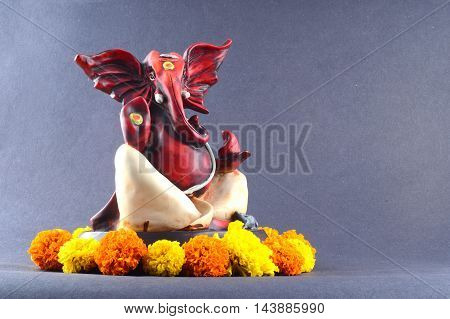 Hindu God Ganesha. Ganesha Idol on grey Background.