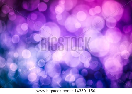 Defocused bokeh. Twinkling light purple bokeh abstract background for Christmas and Happy new year holiday. Festive elegant blurred background with bokeh circular and bright light.