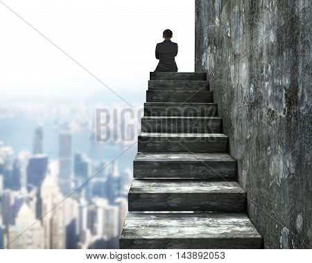 Rear View Of Man Sitting On Top Of Concrete Stairs