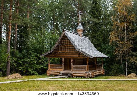 Old orthodox wooden chapel in the forest.