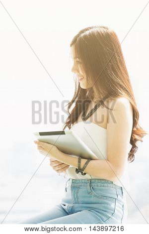 Young pretty business thai woman with tab let in the office.