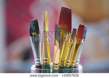 A colourful and detailed photo of paint brushes