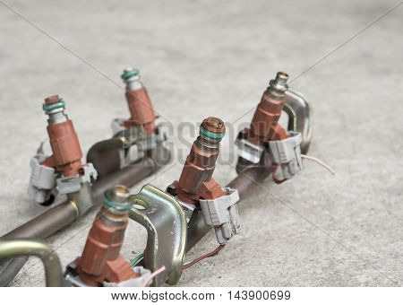 Old and used fuel injectors and fuel injector rail for gasoline engine selective focus