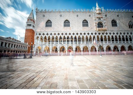 View on San Marco campanille and Doges palace in the center of Venice. Long exposure image technic with motion blurred people