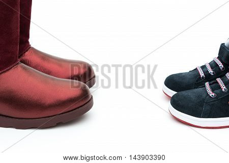 black shoes for son and red ones for mom on white as filiation concept