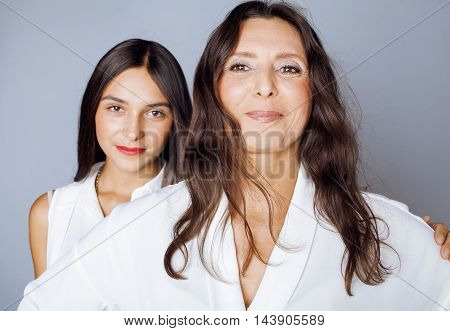 cute pretty teen daughter with mature mothr hugging, fashion style brunette 