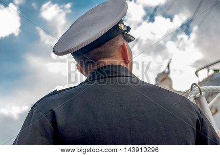 Captain looking at his ship near the port of Antwerp