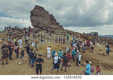 Bucegi Mountains Romania - August 6 2016: Thousands of tourists come to visit the Sphinx the mythical megalith with human face resemblance located at 2216 m altitude on Bucegi Mountains plateau.