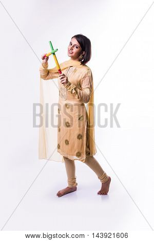 Indian beautiful young girl with garba sticks on Indian Festival Navratri, isolated on white background