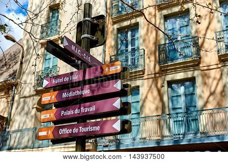 Narbonne France - April 8, 2016: Signpost showing directions to the different buildings and sights in the Narbonne city. Languedoc-Roussillon, France