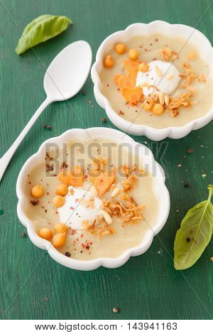 Homemade vegetables soup in two white bowls with creme fraiche