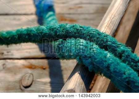 Close up on rope of green color of fishing boat.