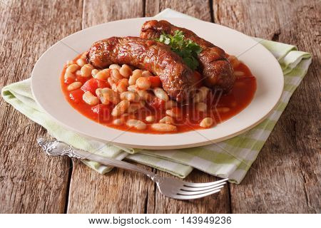 Pork Sausages With Beans And Cooked Tomatoes On A Plate Close-up. Horizontal